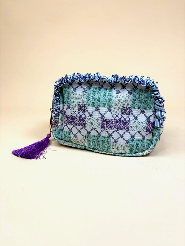 Simply Southern Trail Patch quilted cosmetic bag with ruffle trim, purple tassel zipper pull, and zip-top closure.