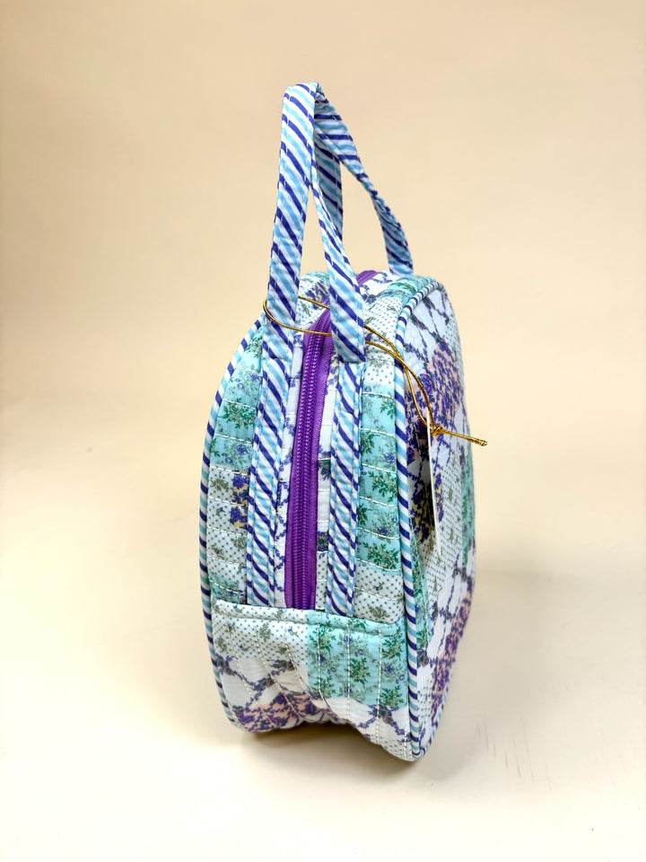 Side view of the Simply Southern Trail Patch quilted lunch bag featuring dual handles, insulated construction, and purple zip closure.
