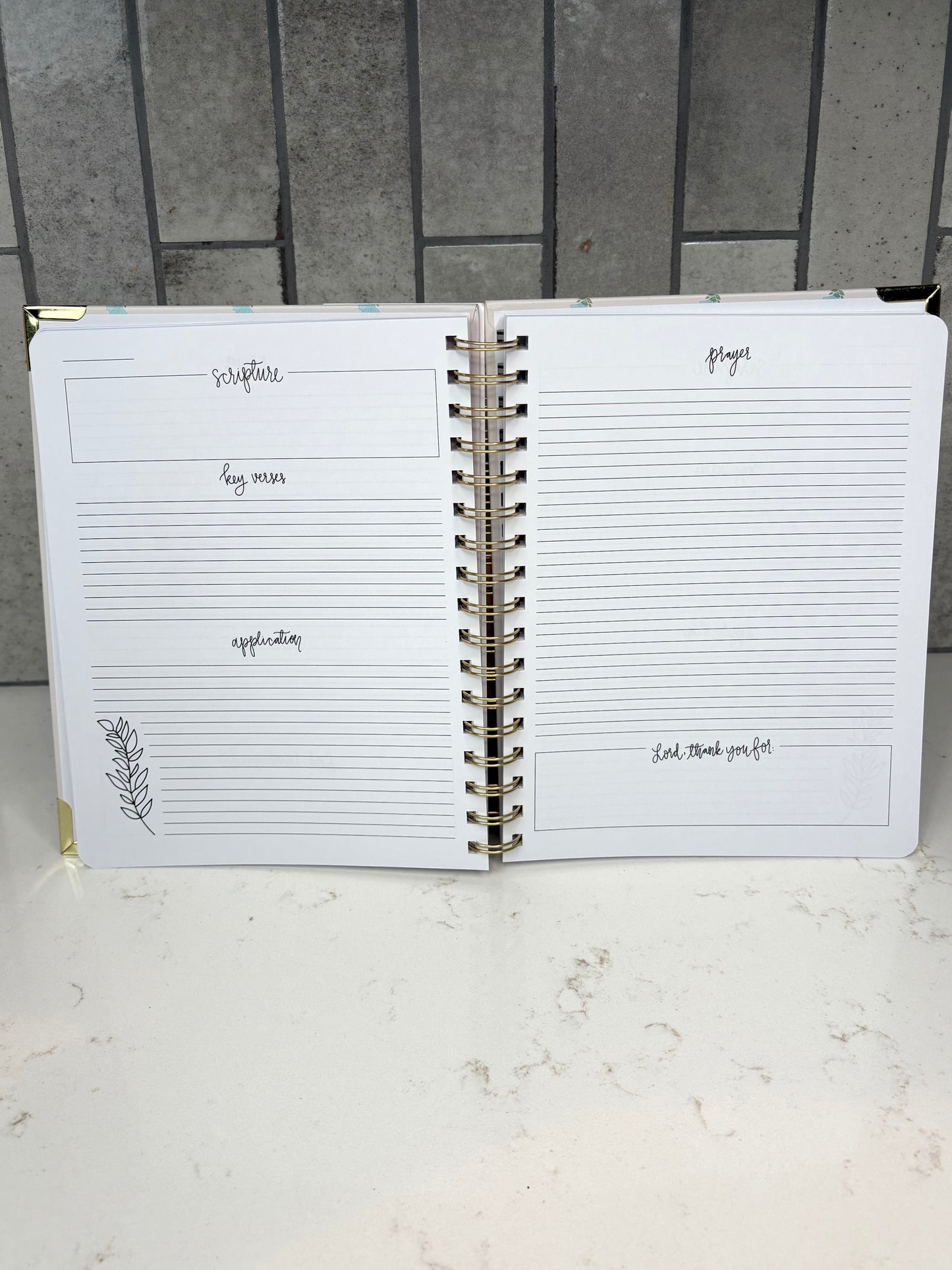 Christian devotional journal interior with guided sections for scripture, key verses, application, prayer, and gratitude for daily Bible study and faith journaling.