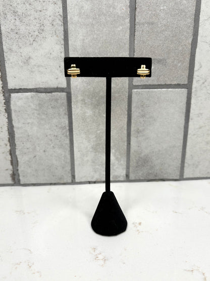 Gold knot stud earrings displayed on black jewelry stand – minimalist women’s boutique earrings