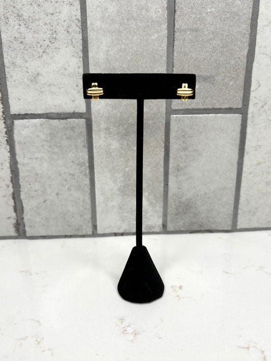 Gold knot stud earrings displayed on black jewelry stand – minimalist women’s boutique earrings