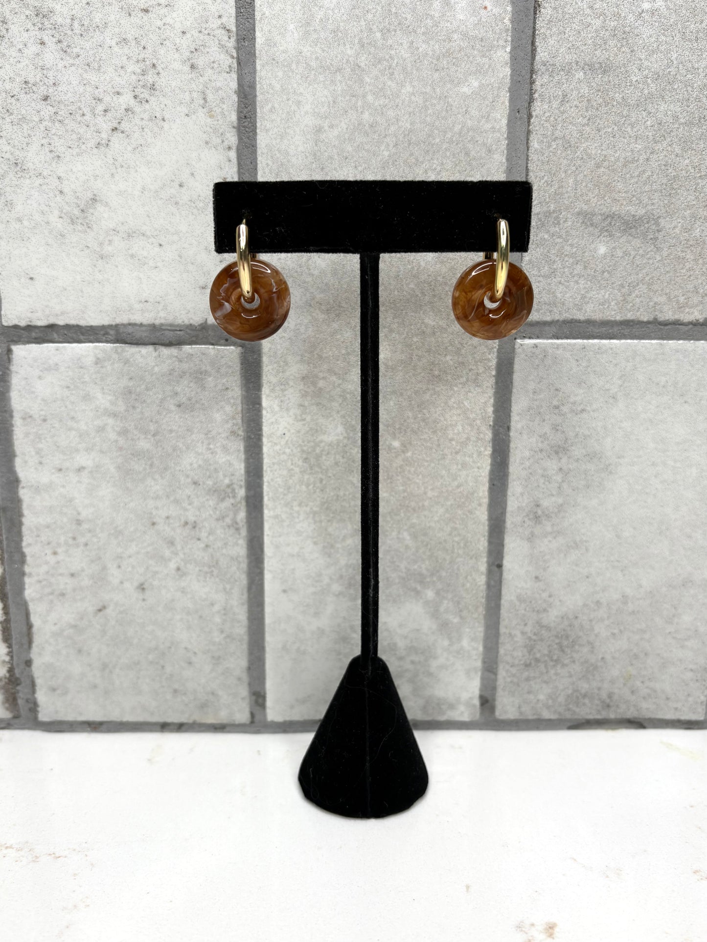 Brown marbled drop earrings with gold hoop on black display stand – trendy women’s boutique jewelry