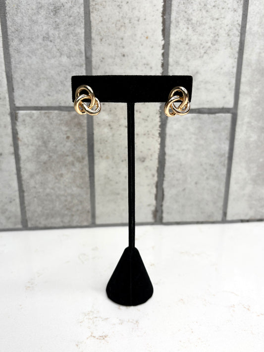 Gold knot stud earrings on black display stand – classic women’s boutique jewelry