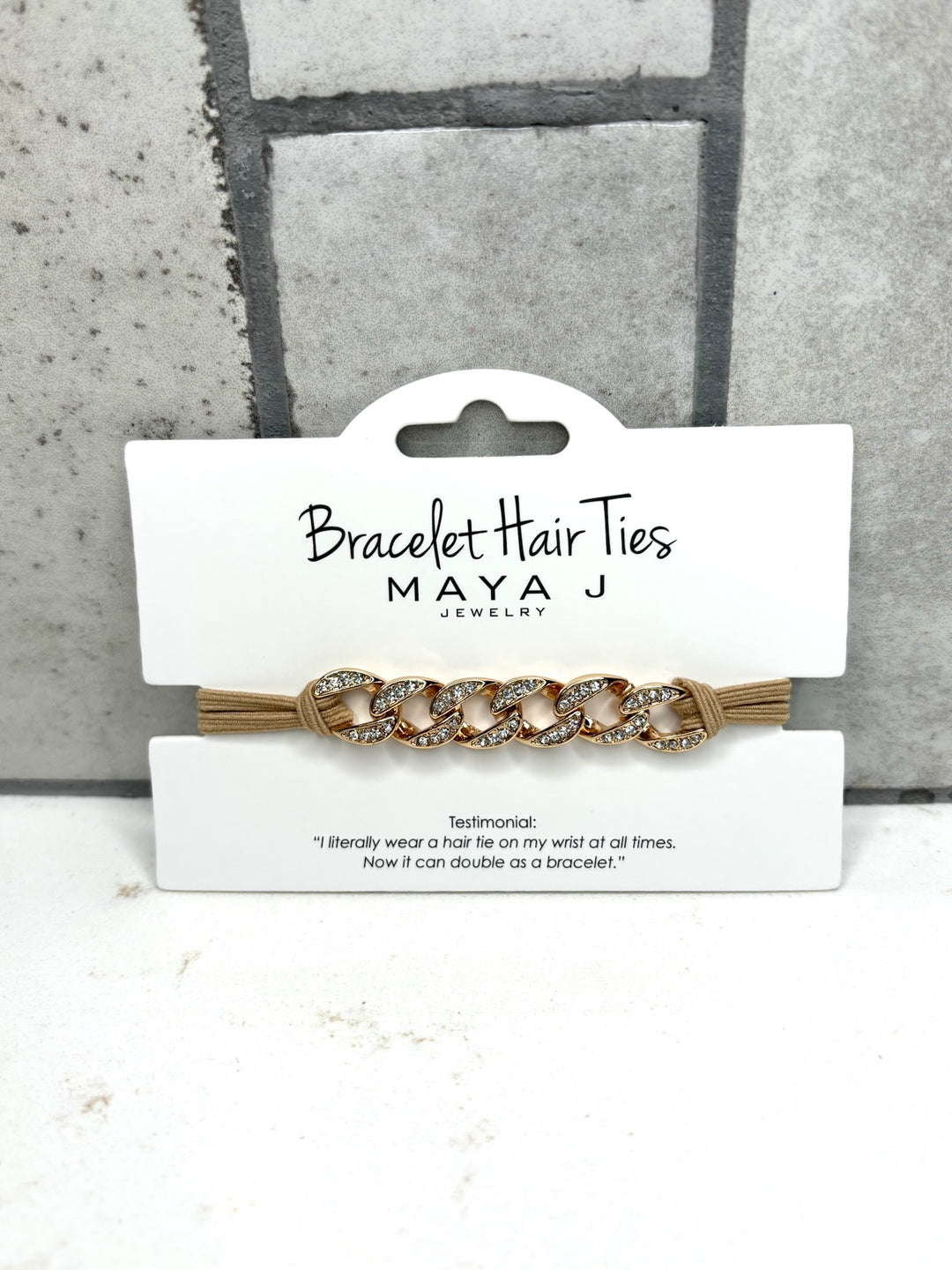 Gold chain bracelet hair tie with rhinestone accents, beige elastic hair tie bracelet, Maya J Jewelry accessory, crystal chain hair tie, fashionable wrist hair tie for women, chic bracelet ponytail holder, gold hair tie bracelet accessory