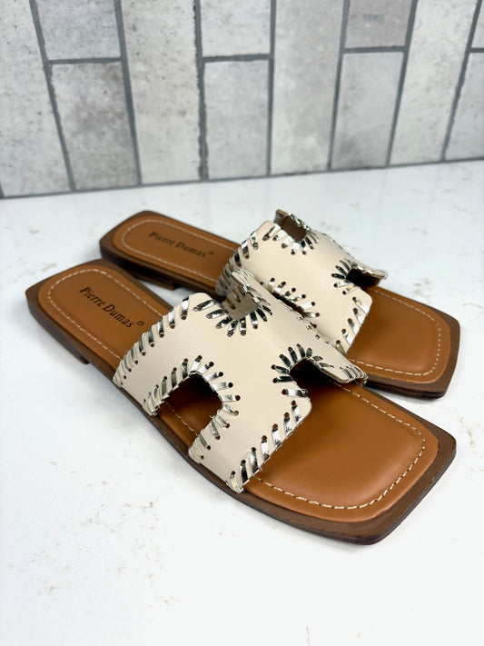 Cream leather slide sandals with whipstitch detail and tan sole, Pierre Dumas women’s flat sandals