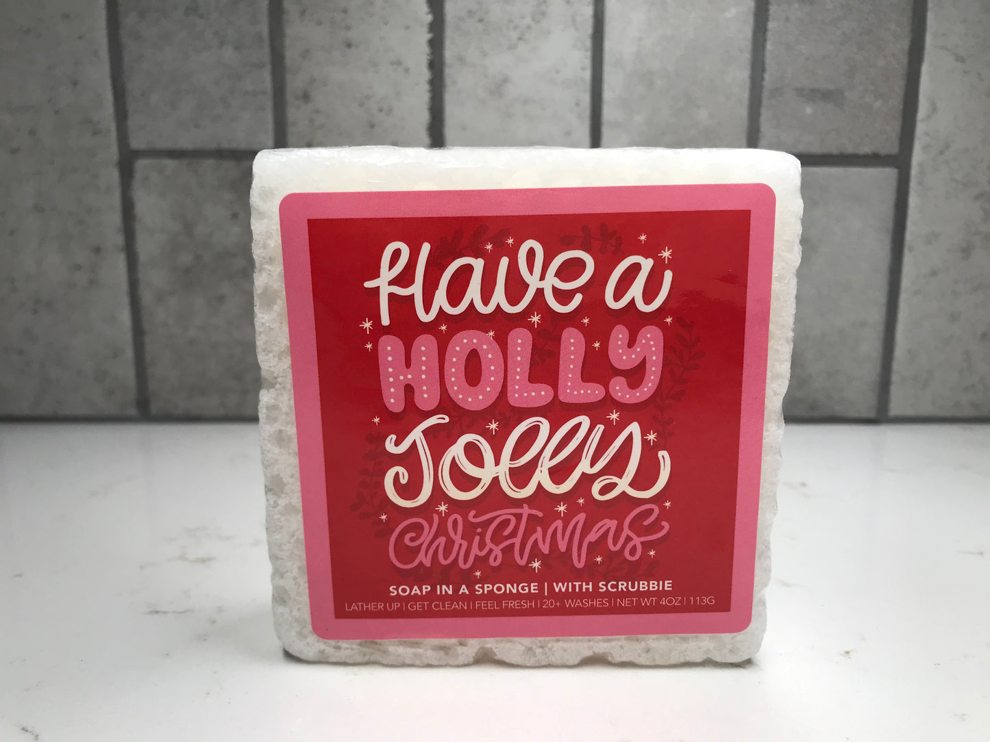 Soap in a sponge with a red label on a tiled background