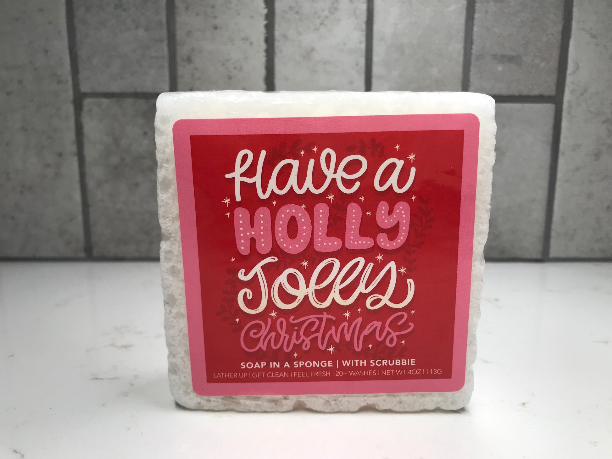 Soap in a sponge with a red label on a tiled background