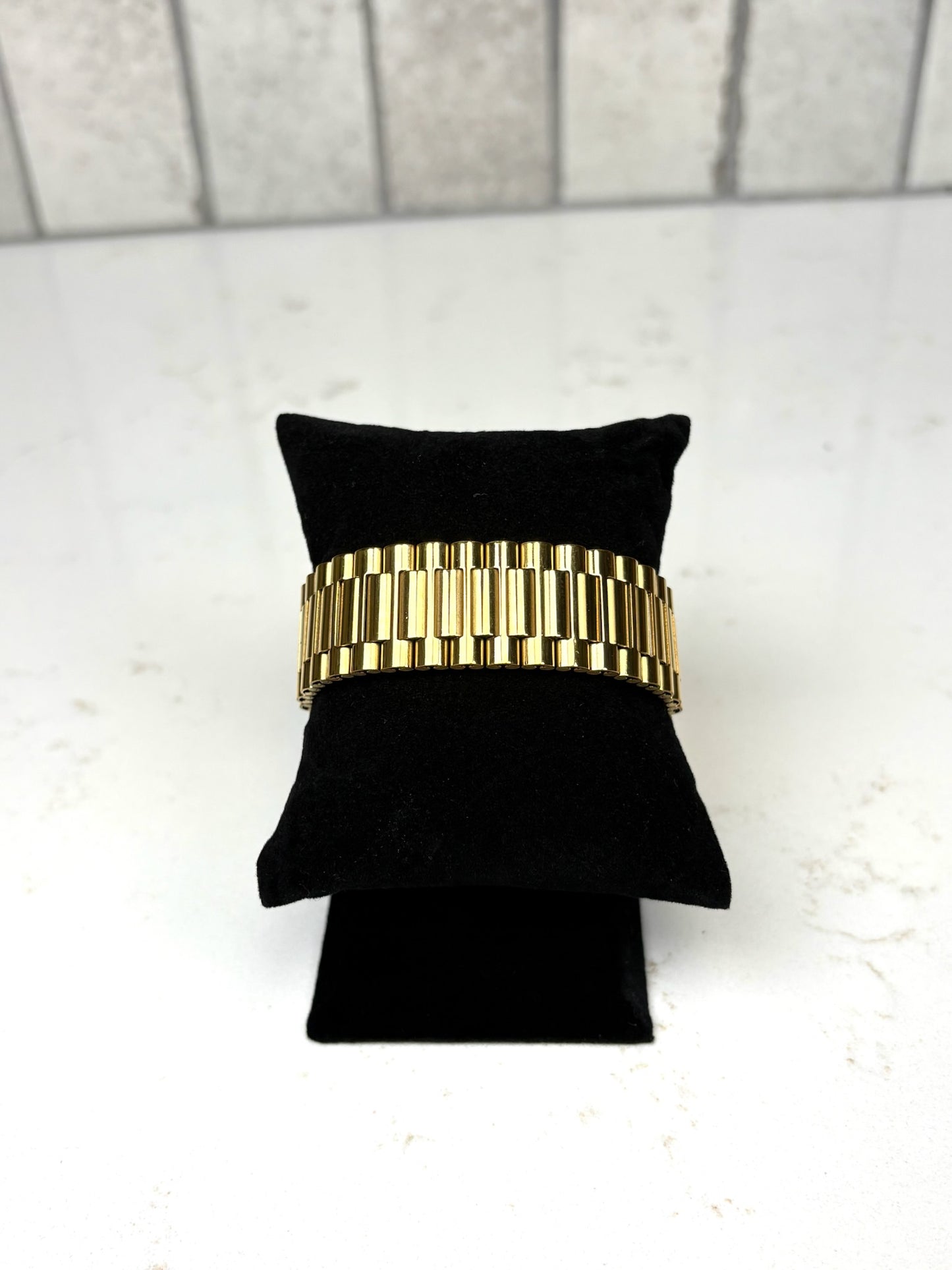 Chan Sutt Pearls thick gold watch band bracelet on black display, chunky gold link statement bracelet