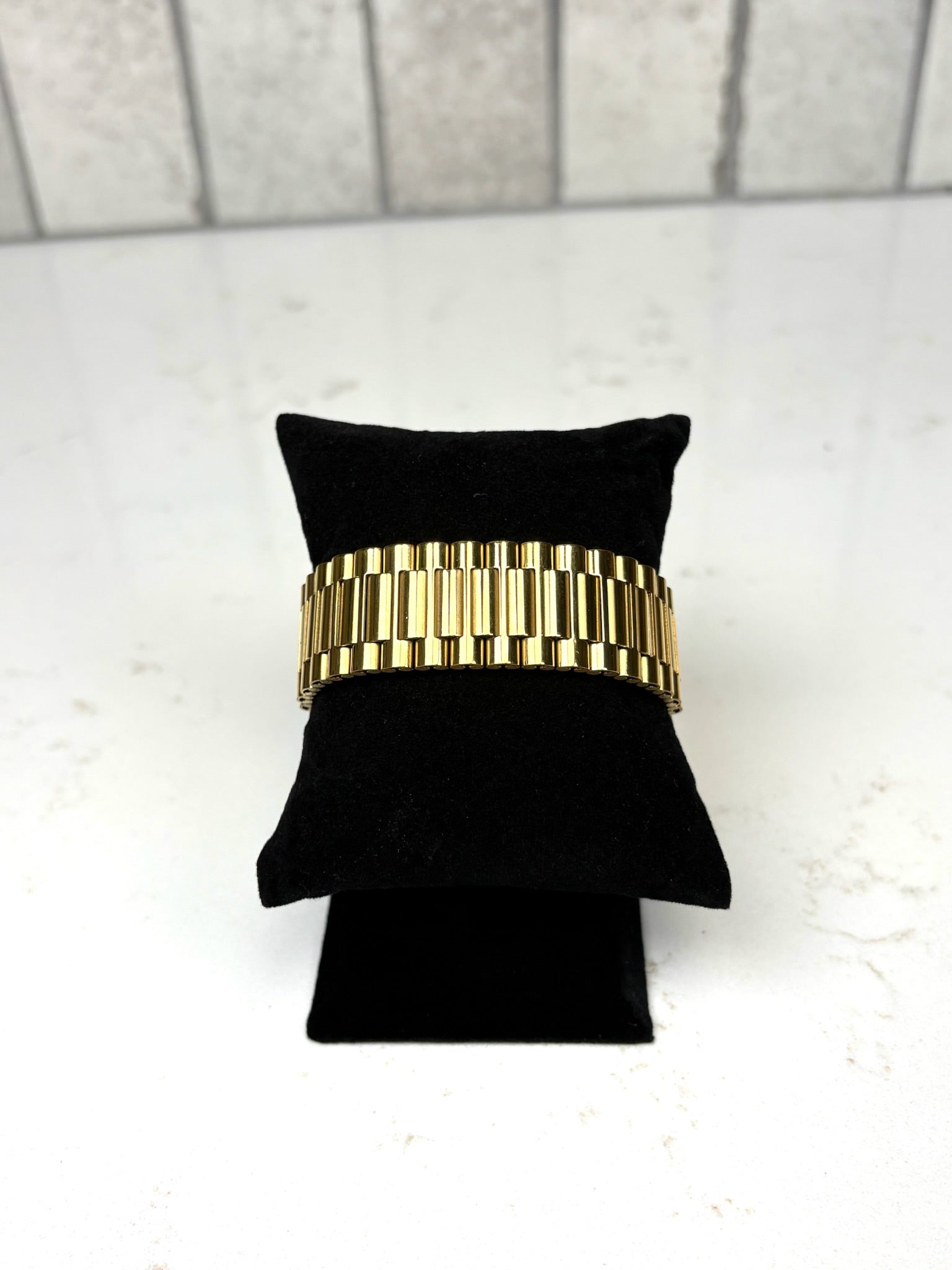 Chan Sutt Pearls thick gold watch band bracelet on black display, chunky gold link statement bracelet