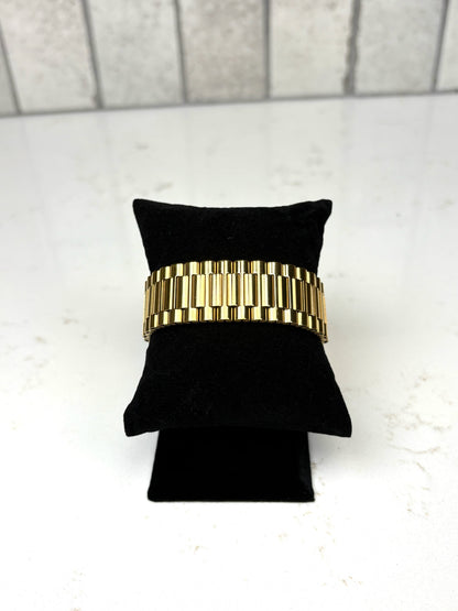 Chan Sutt Pearls thick gold watch band bracelet on black display, chunky gold link statement bracelet