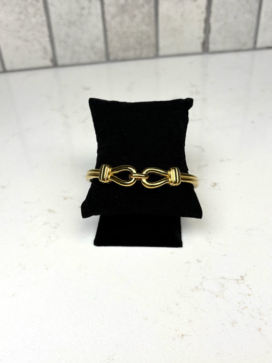 Chan Sutt Pearls Abby bracelet gold link bangle on black display, modern gold statement bracelet for women