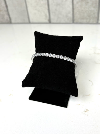 Chan Sutt Pearl silver crystal tennis bracelet stretch design side view on black cushion