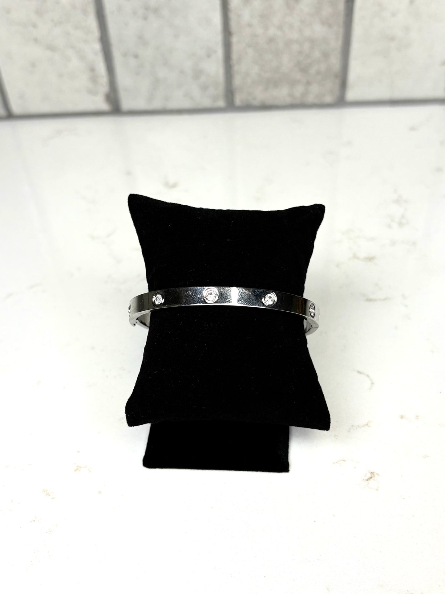 Chan Sutt Pearl silver luxe bangle bracelet with crystal accents on black display pillow