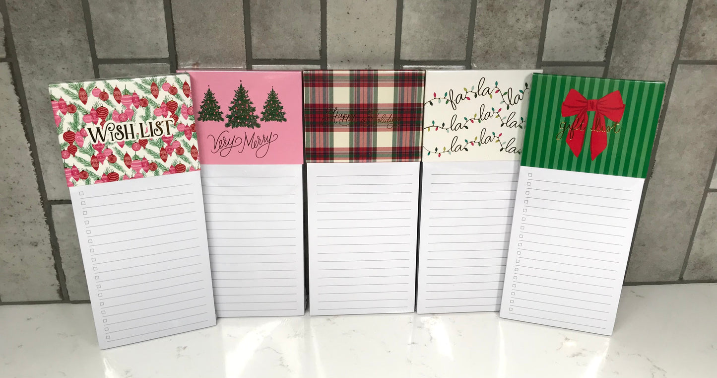 Set of five decorative notepads with various designs on a tiled floor background.