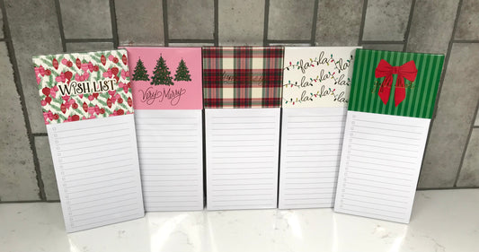Set of five decorative notepads with various designs on a tiled floor background.