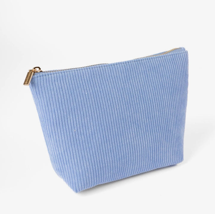 Cornflower blue corduroy carry-all pouch with gold zipper and roomy interior, perfect for makeup, travel, and everyday organization.