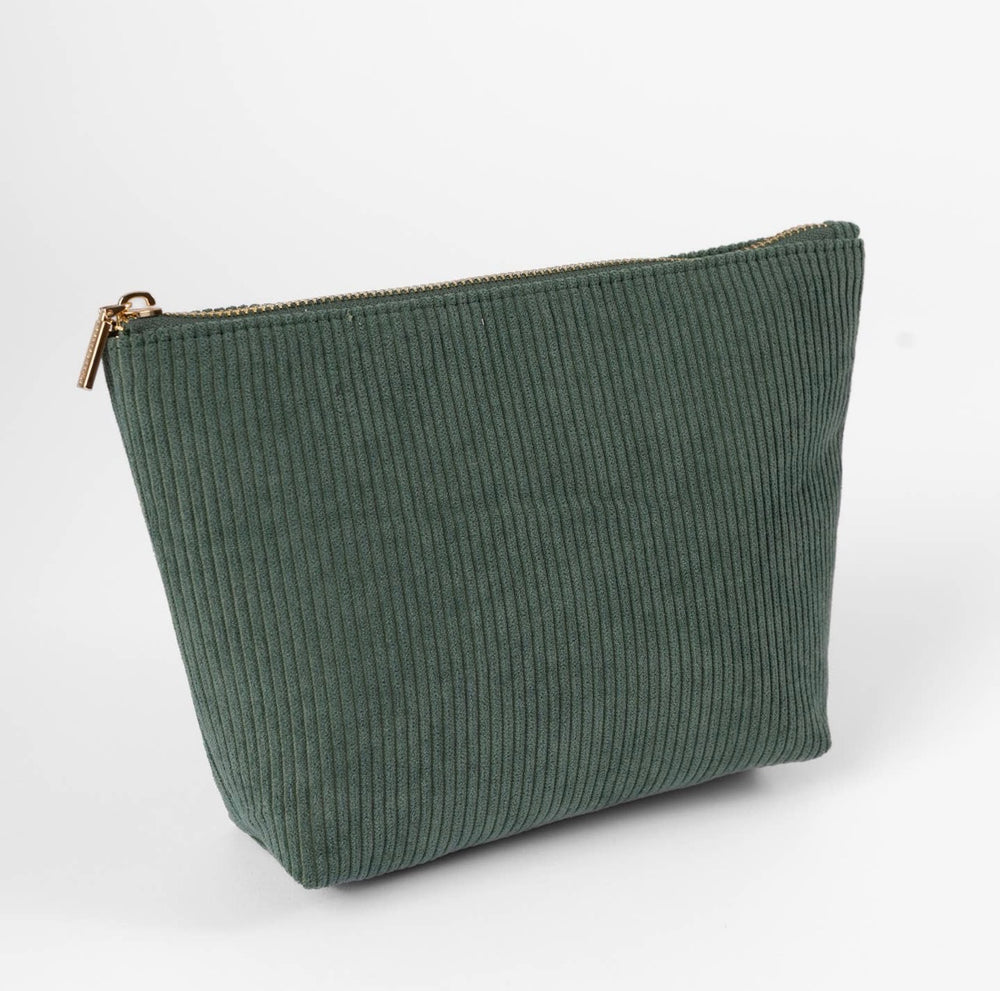 Jade green corduroy carry-all pouch featuring a gold zipper and cotton-lined interior for organizing cosmetics, toiletries, and daily essentials.