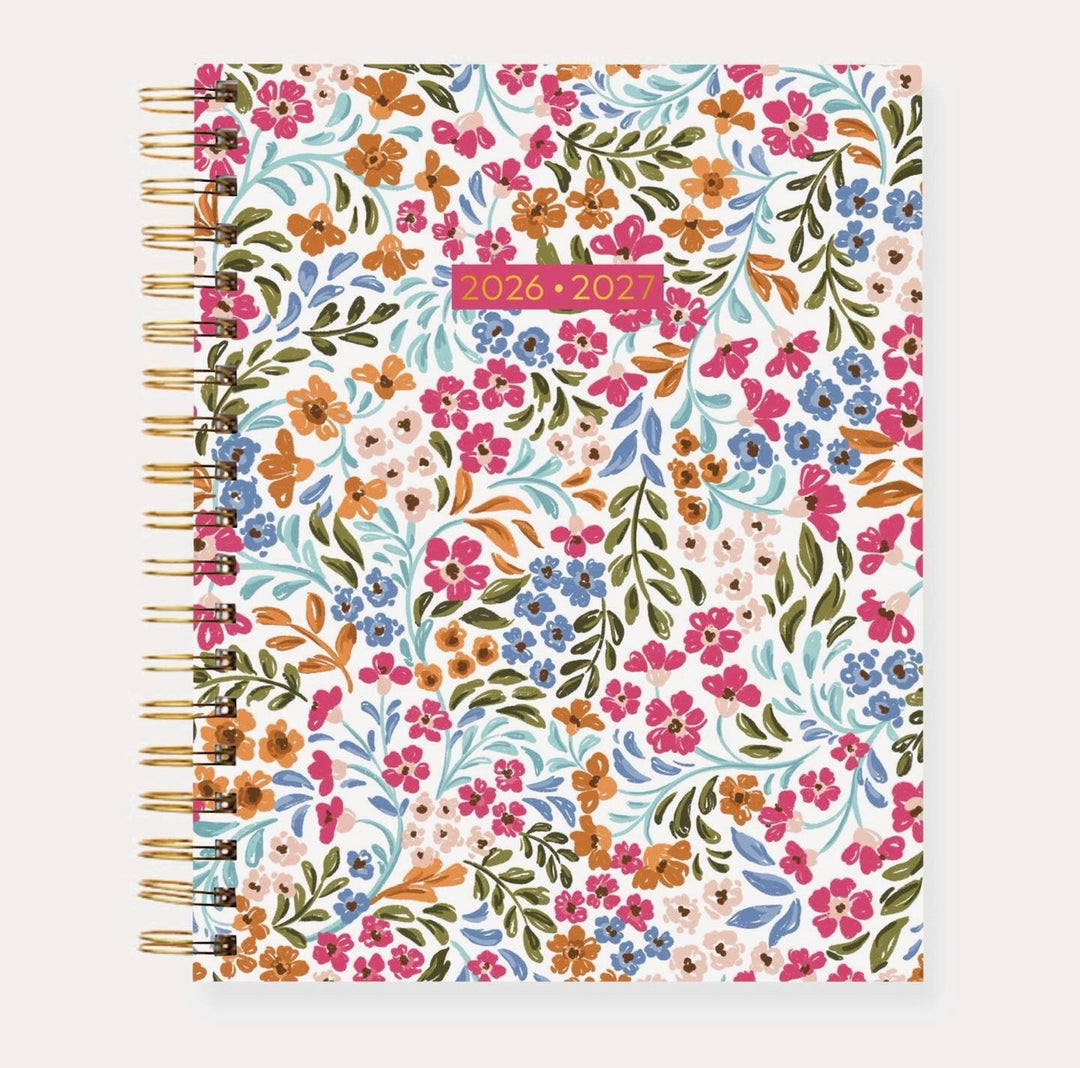 Elyse Breanne Designs 2026–2027 Academic Planner in the Floral Filigree pattern featuring a sage green cover with delicate white floral illustrations, gold spiral binding, and a soft-touch laminated finish.