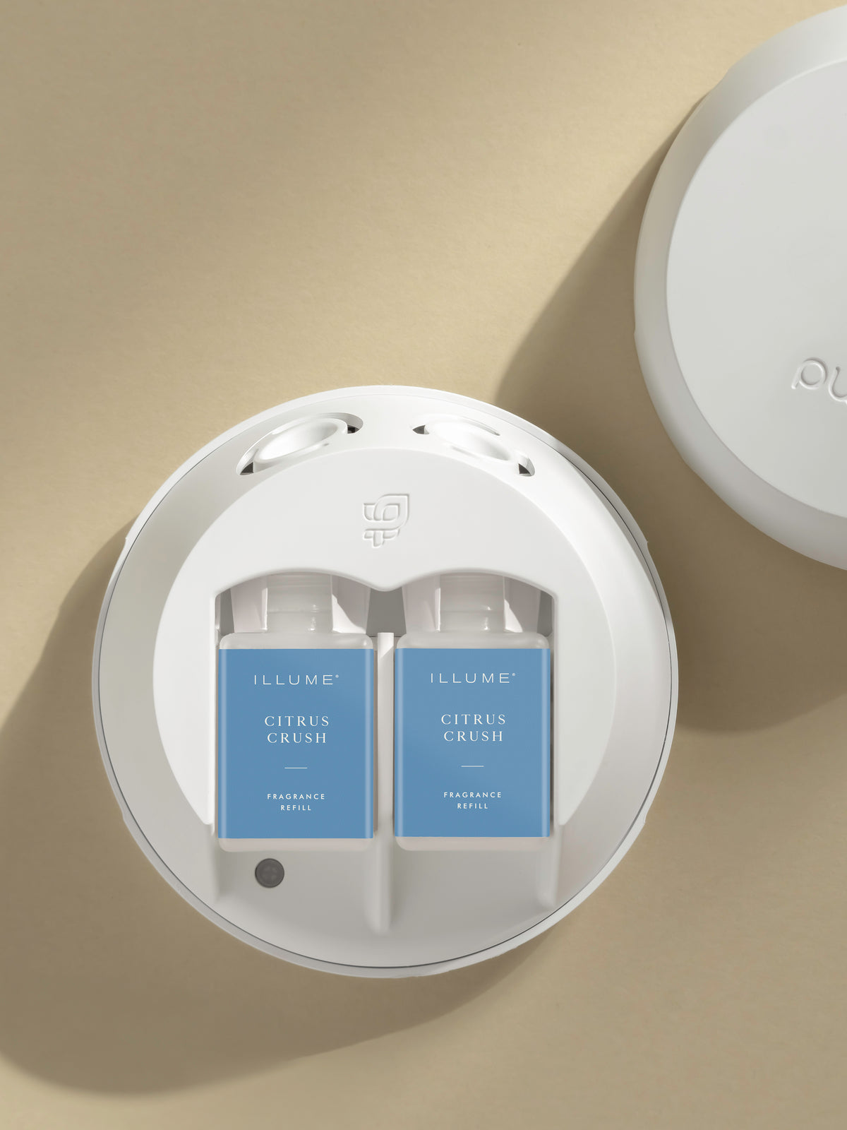 ILLUME Citrus Crush home fragrance refills displayed in Pura diffuser