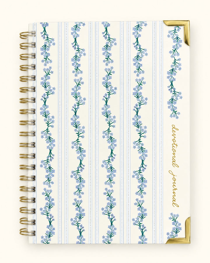 Petal Thread Christian devotional journal with blue floral striped hardcover, gold spiral binding and gold corner accents.