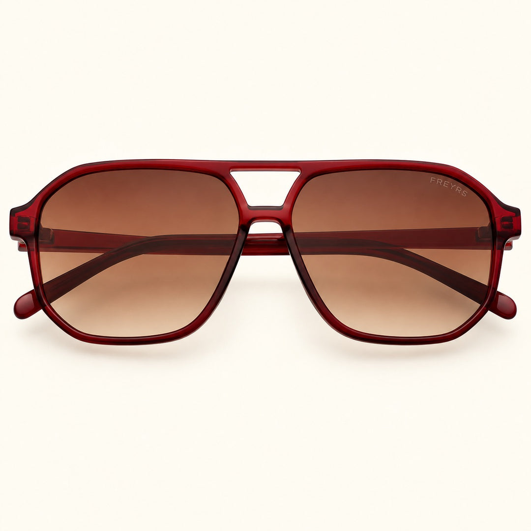Front view of FREYRS Billie unisex aviator sunglasses in Dark Cherry featuring translucent deep red acetate frames, brown gradient lenses, and a retro double-bridge design.
