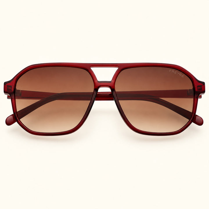Front view of FREYRS Billie unisex aviator sunglasses in Dark Cherry featuring translucent deep red acetate frames, brown gradient lenses, and a retro double-bridge design.