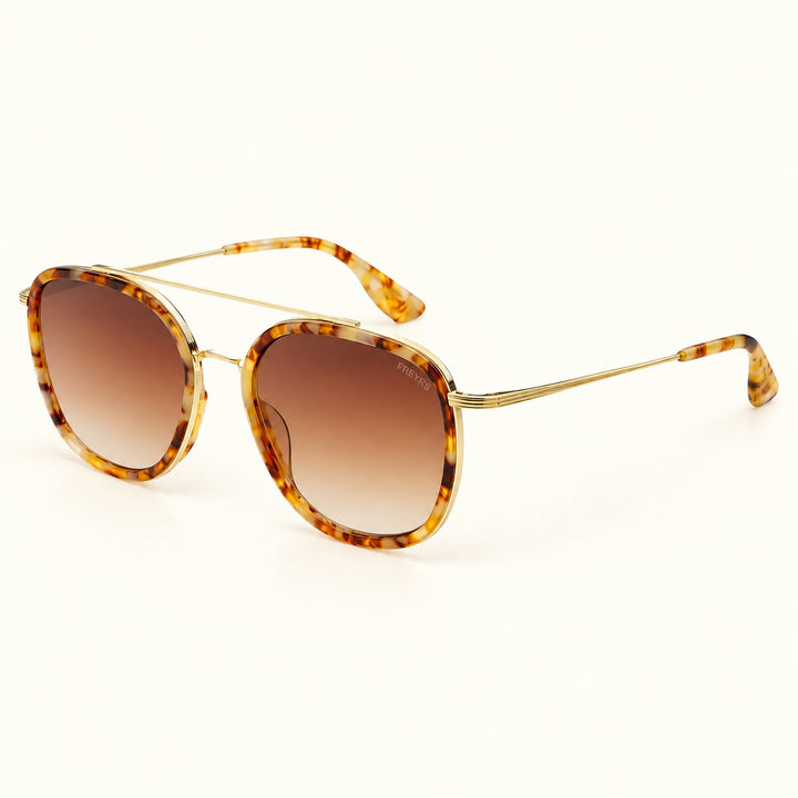 Angled view of FREYRS Weston Brown Pearl sunglasses showing tortoiseshell acetate frames, brown gradient lenses, slim gold-tone temples, and matching tortoiseshell tips.