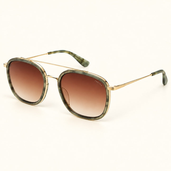 Angled view of FREYRS Weston Emerald sunglasses showing green patterned acetate frames, brown gradient lenses, slim gold-tone temples, and matching green tips.