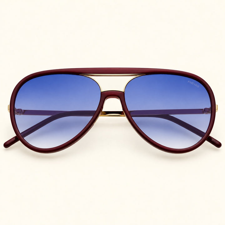 Front view of FREYRS Shay unisex aviator sunglasses in Burgundy featuring deep burgundy acetate frames, blue gradient lenses, and a gold-tone double-bridge design.