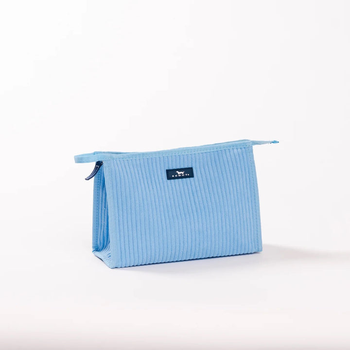 A light blue ribbed fabric zippered pouch with a small black brand label on the front, photographed on a clean white background.