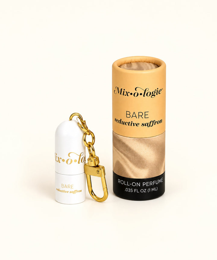 Mixologie Bare Seductive Saffron 1 mL mini roll-on perfume oil keychain with gold clip and warm golden cylindrical packaging.