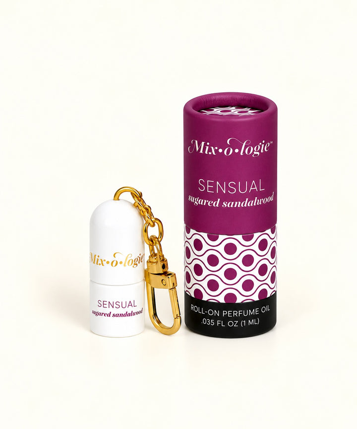 Mixologie Sensual Sugared Sandalwood 1 mL perfume oil keychain with gold clip and purple patterned cylindrical packaging.