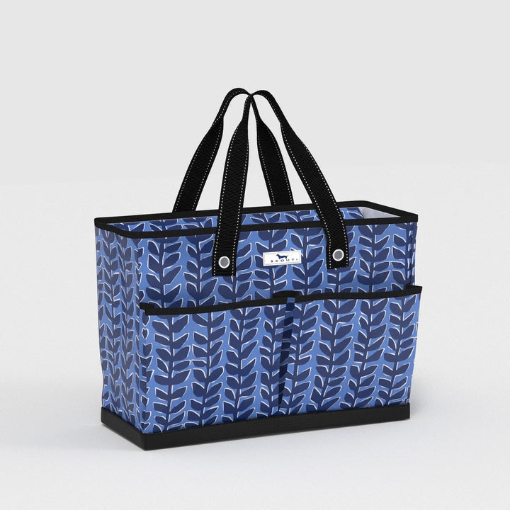 SCOUT Ben Pocket Tote large utility tote bag in Indigrow blue botanical leaf print with long black shoulder straps, reinforced black trim, structured open-top design, exterior front pockets and durable flat bottom.