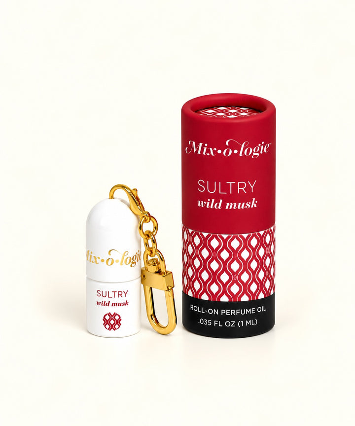 Mixologie Sultry Wild Musk mini roll-on perfume keychain with gold clasp, white bottle, and red patterned fragrance packaging.