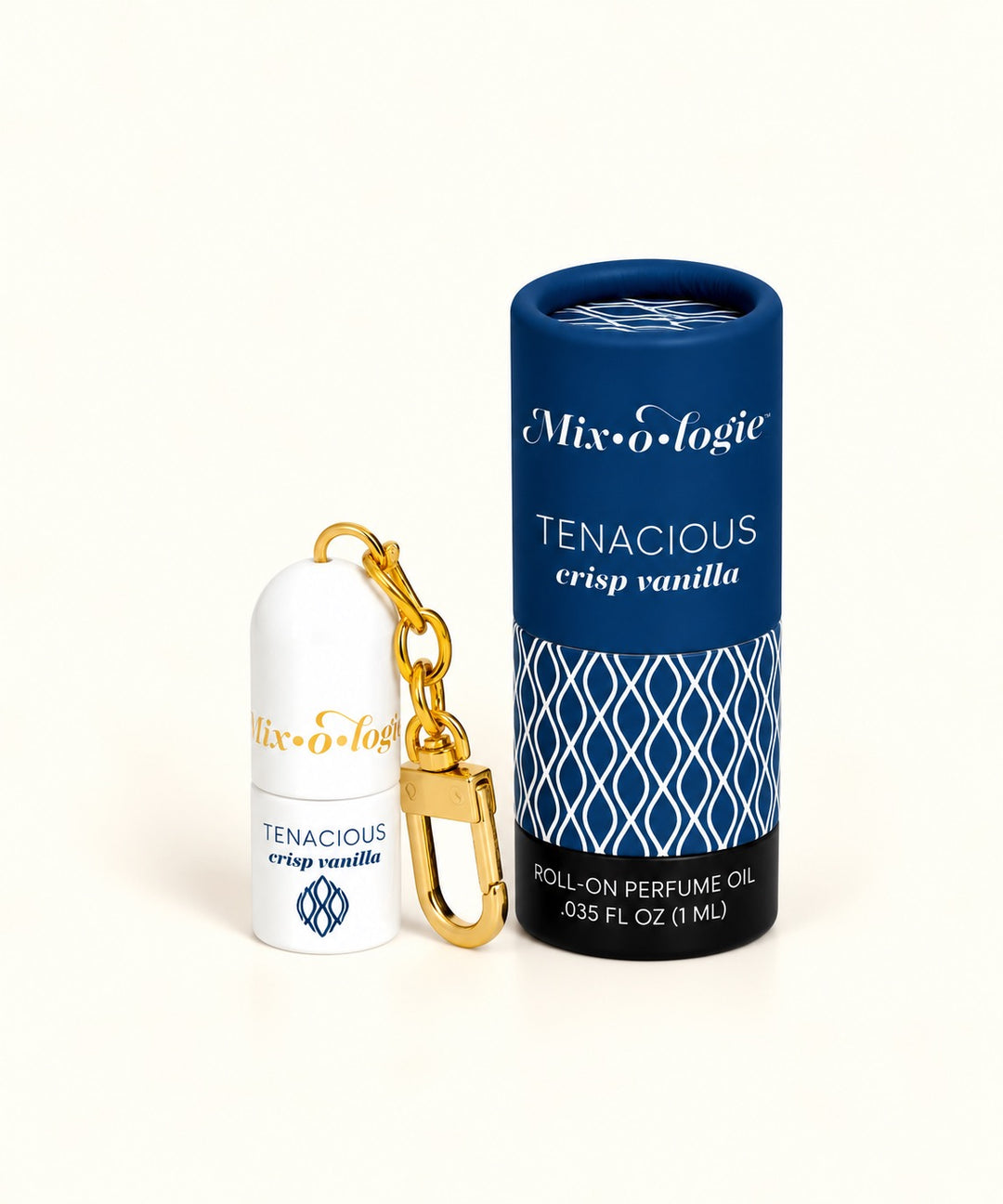 Mixologie Tenacious Crisp Vanilla mini perfume rollerball keychain with gold clasp and navy blue patterned packaging.