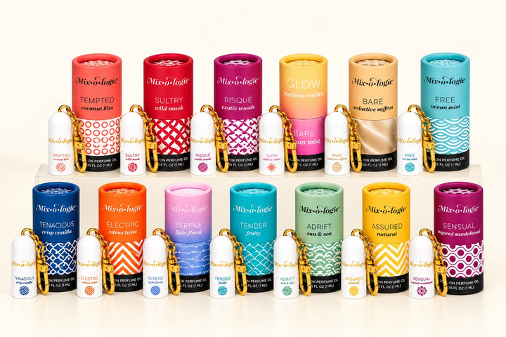 Mixologie Roll-On Perfume Oil Collection featuring 13 fragrances with colorful packaging and mini perfume keychains, displayed on a cream background at Square 1 Boutique.