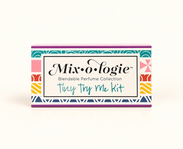 Mixologie Tiny Try Me Kit 10-piece perfume sampler in colorful geometric gift packaging, featuring the Blendable Perfume Collection of alcohol-free fragrance oils.