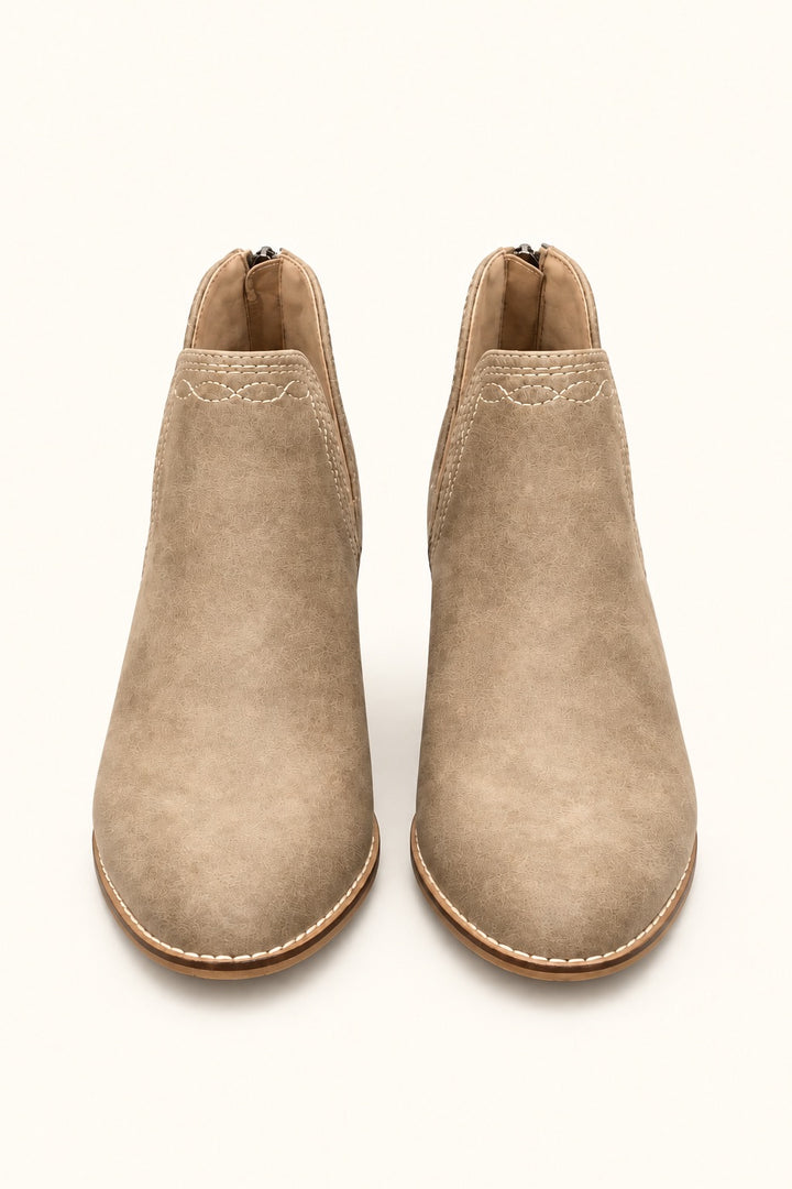 Front view of Corkys Dive Bar taupe ankle booties featuring western-inspired contrast stitching, pointed toes, and a neutral textured finish.