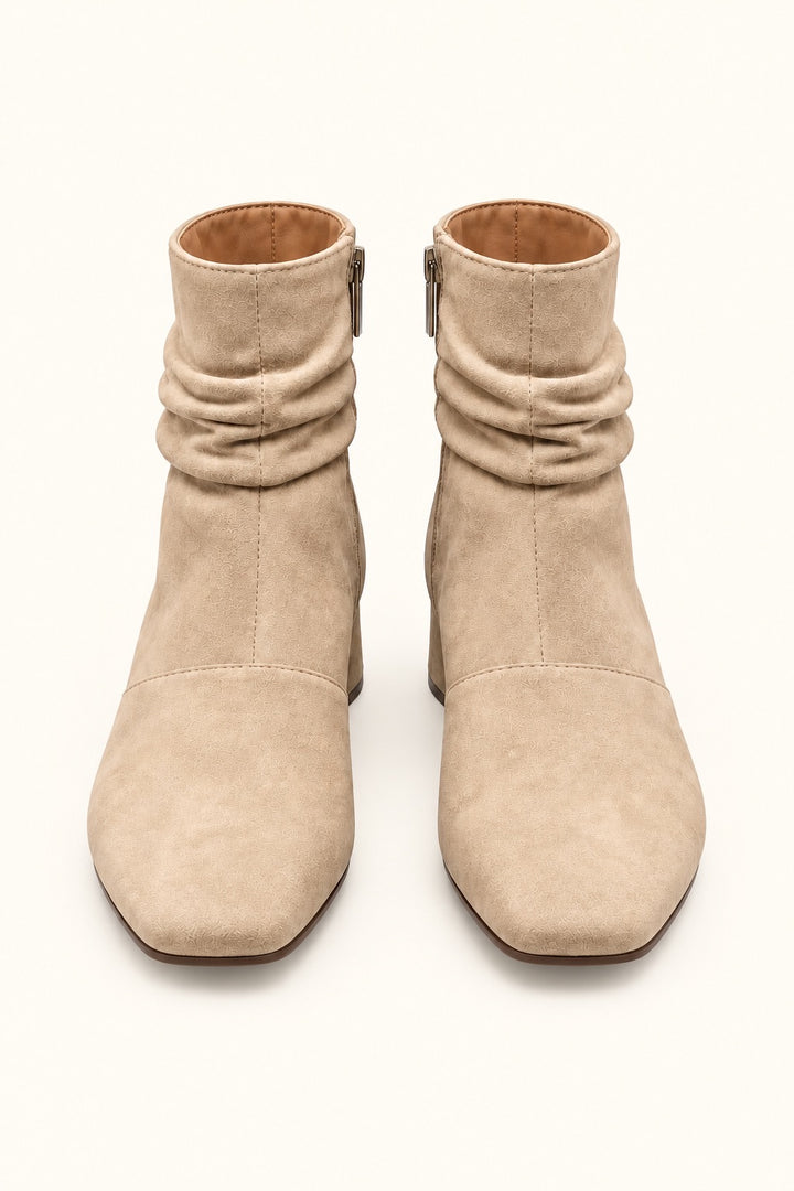 Front view of Corkys Addicted sand faux suede ankle boots featuring square toes, ruched ankle detailing, and neutral tan finish.