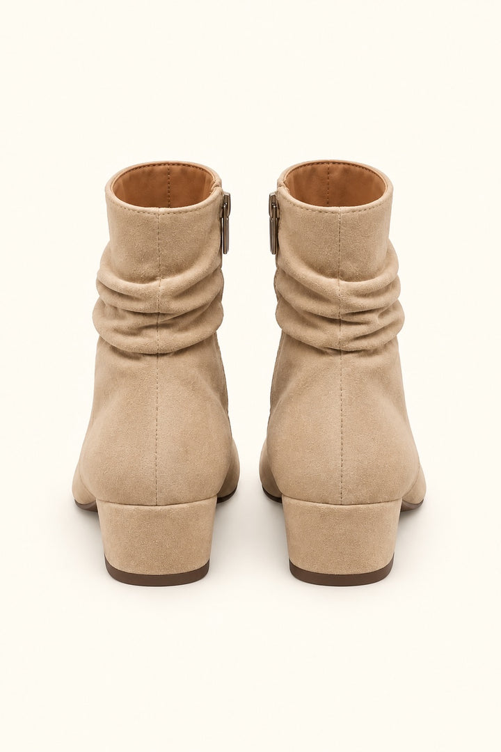 Rear view of Corkys Addicted sand faux suede ankle boots showing ruched shafts, center back seams, side zippers, and low block heels.