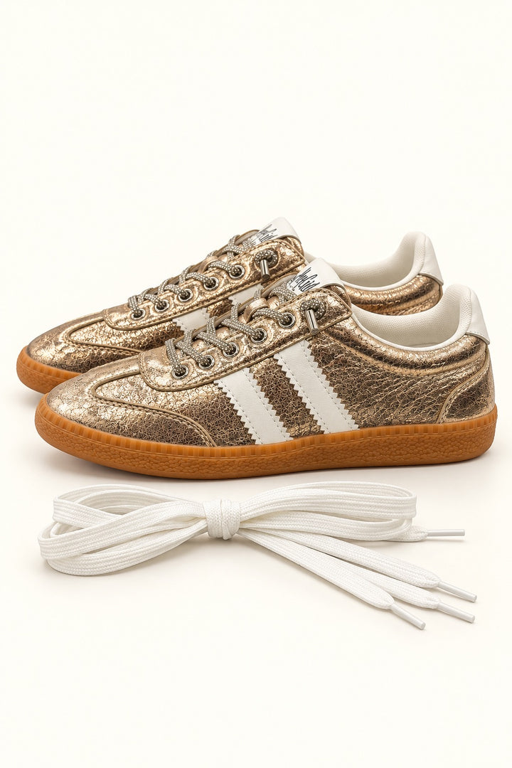 Corkys Heads Up Gold Metallic sneaker with rhinestone-accented laces, white stripes, gum sole, and included white replacement shoelaces.