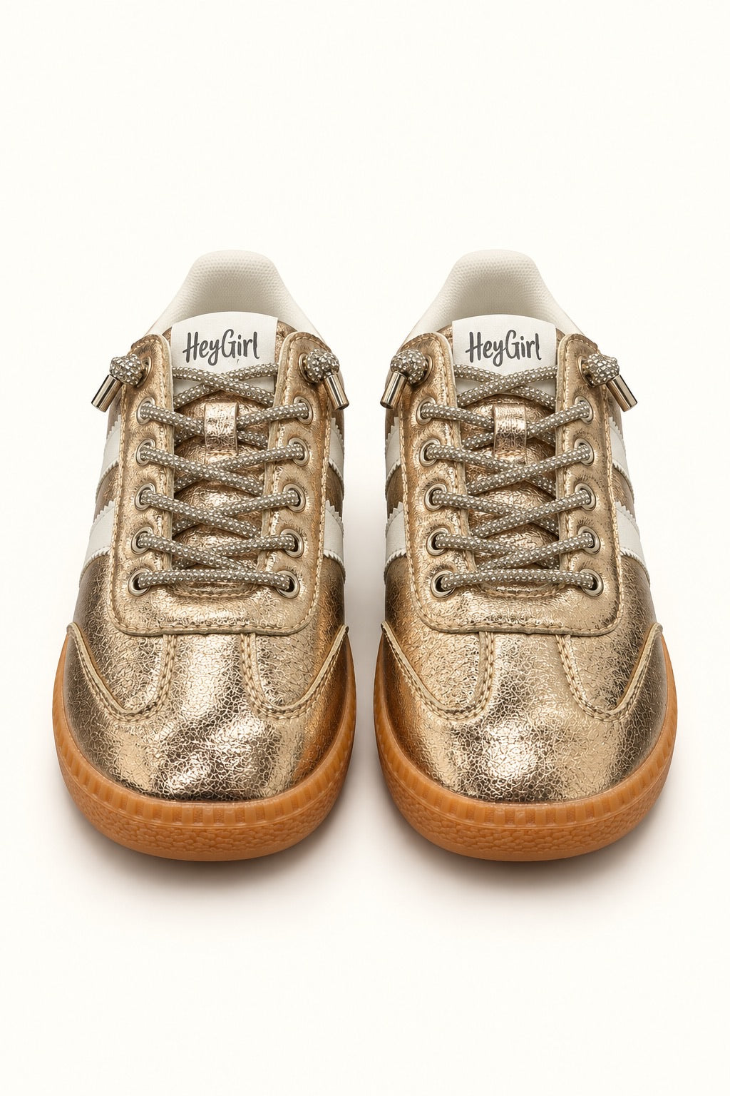 Front view of Corkys Heads Up Gold Metallic women’s sneakers featuring sparkling rhinestone laces, white accents, and gum soles.
