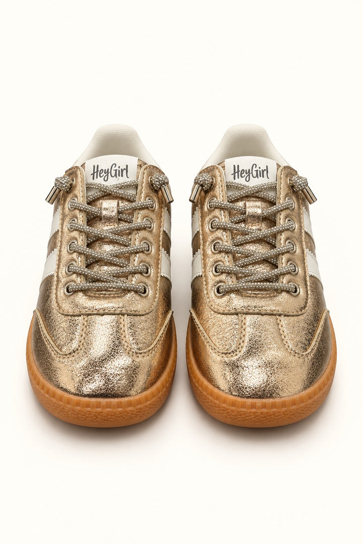 Front view of Corkys Heads Up Gold Metallic women’s sneakers featuring sparkling rhinestone laces, white accents, and gum soles.