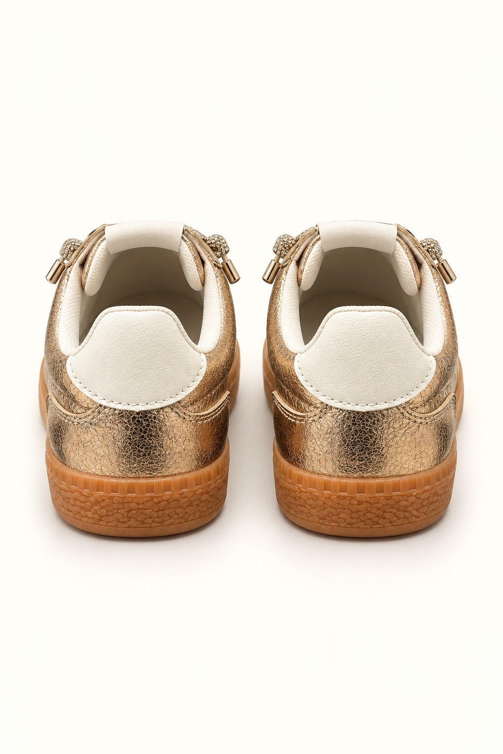 Rear view of Corkys Heads Up Gold Metallic sneakers featuring white heel tabs, metallic gold uppers, and textured gum soles.