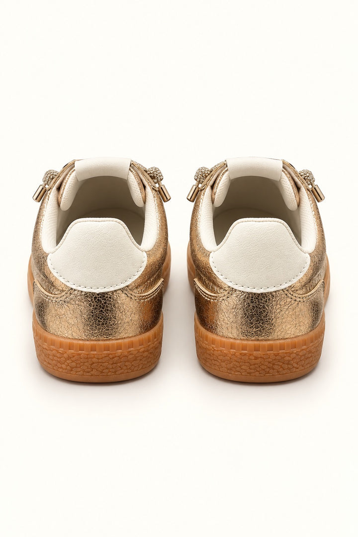 Rear view of Corkys Heads Up Gold Metallic sneakers featuring white heel tabs, metallic gold uppers, and textured gum soles.