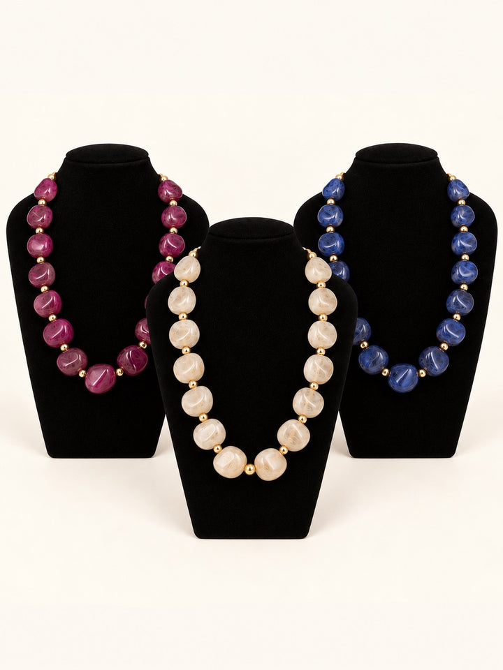 Lindon Statement Beaded Necklace collection in Plum, Cream, and Blue featuring oversized resin beads and gold-tone accents at Square 1 Boutique.