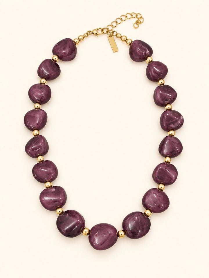 Lindon Plum Beaded Statement Necklace with rich purple-pink resin beads, gold-tone accents, and adjustable lobster clasp closure.