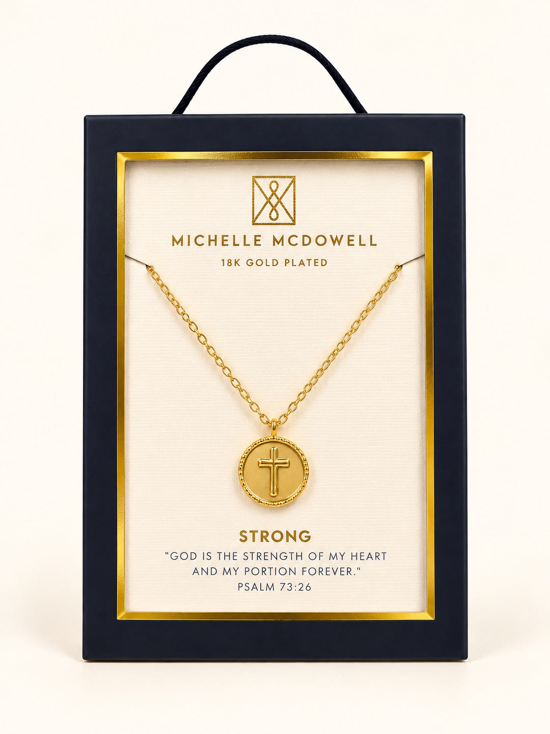 Michelle McDowell Saved Gold Cross Necklace in branded gift packaging featuring an 18K gold-plated chain, round cross pendant, and Strong inspirational scripture card with Psalm 73:26.