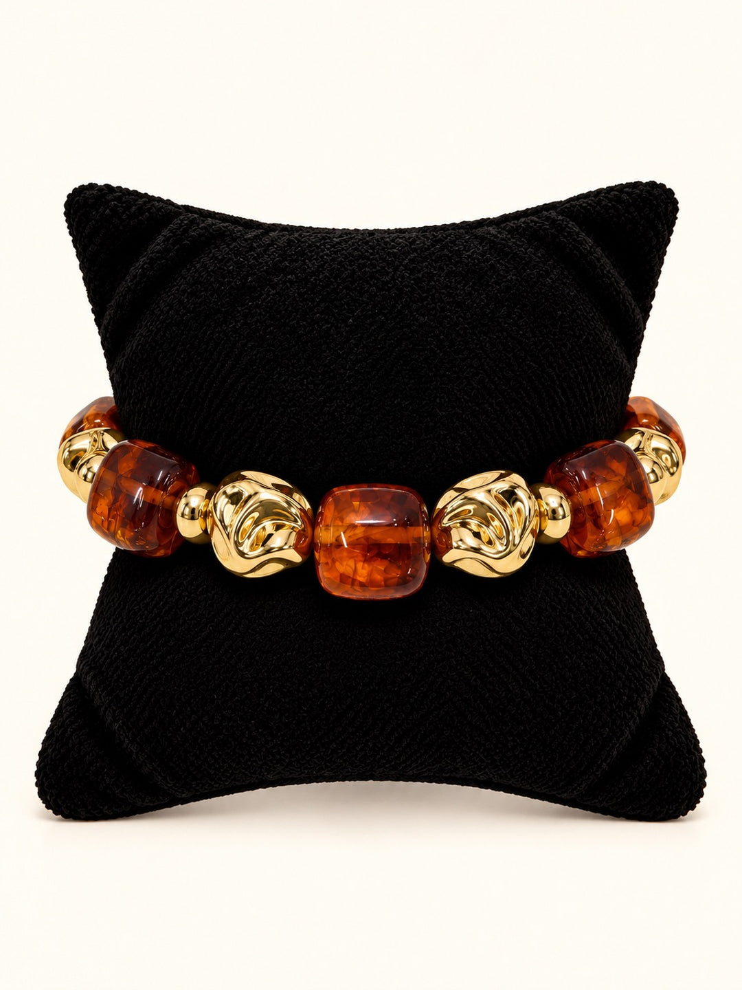 Layla Tortoise Bracelet featuring oversized translucent amber-brown beads alternating with sculptural polished gold-tone beads, arranged in a circle on a cream studio background at Square 1 Boutique.