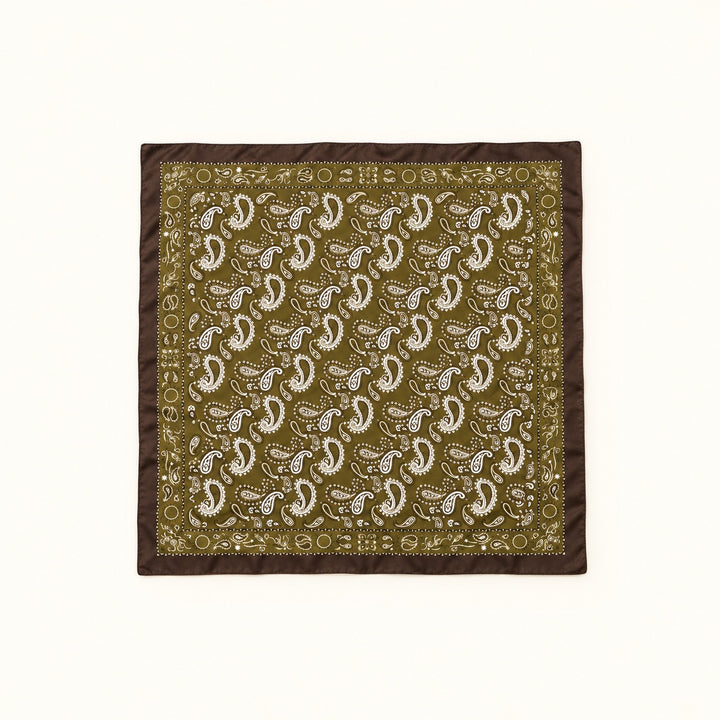 Olive paisley border scarf fully opened in a square flat lay, featuring white paisley print and dark brown trim on a cream background.
